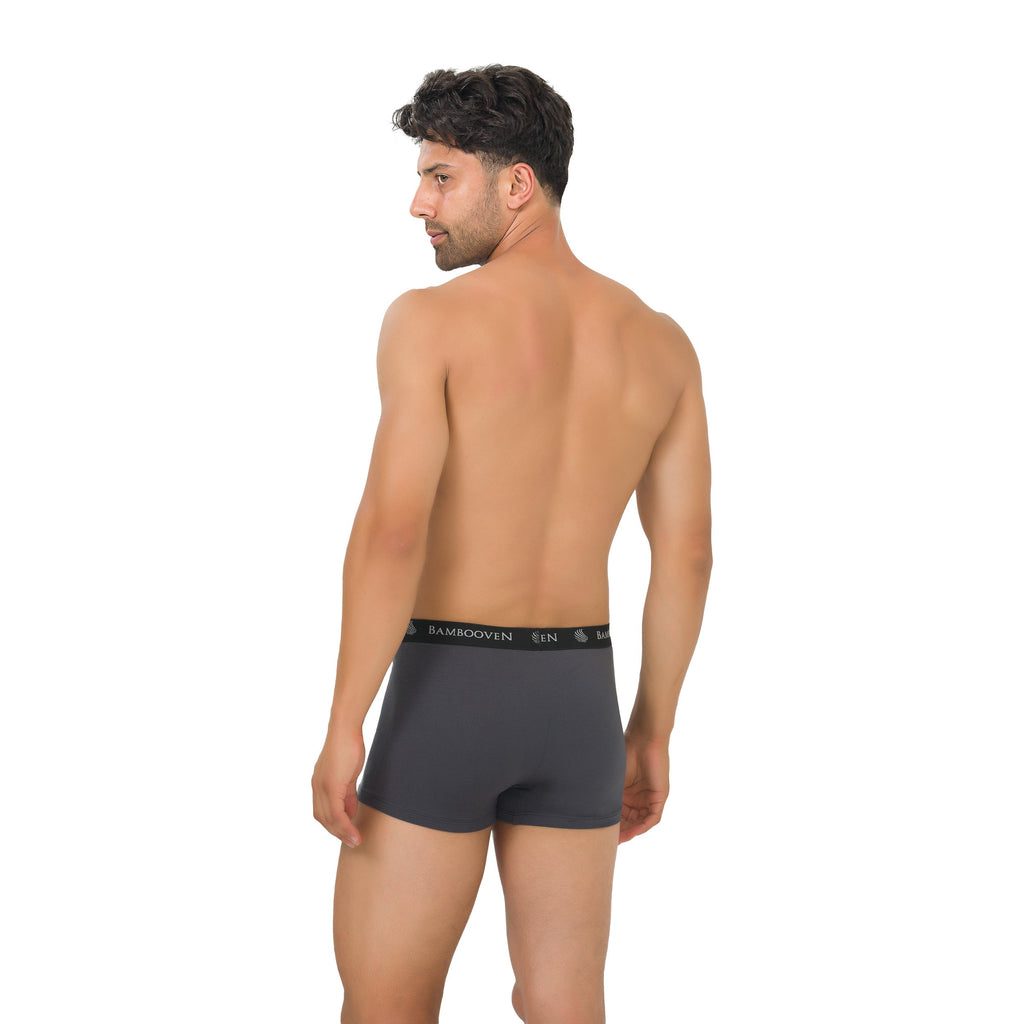 Man wearing a dark gray boxer brief with 'Kamboven' branding on a white background
